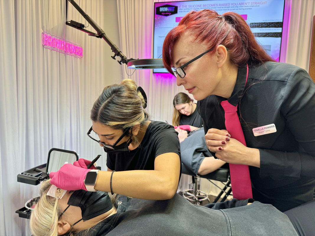 Student practicing microblading strokes during certification training in Dallas