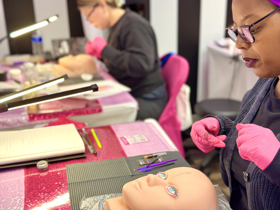 Student practicing brow mapping in Texas certification class Classroom exercise showing student mapping brows with string