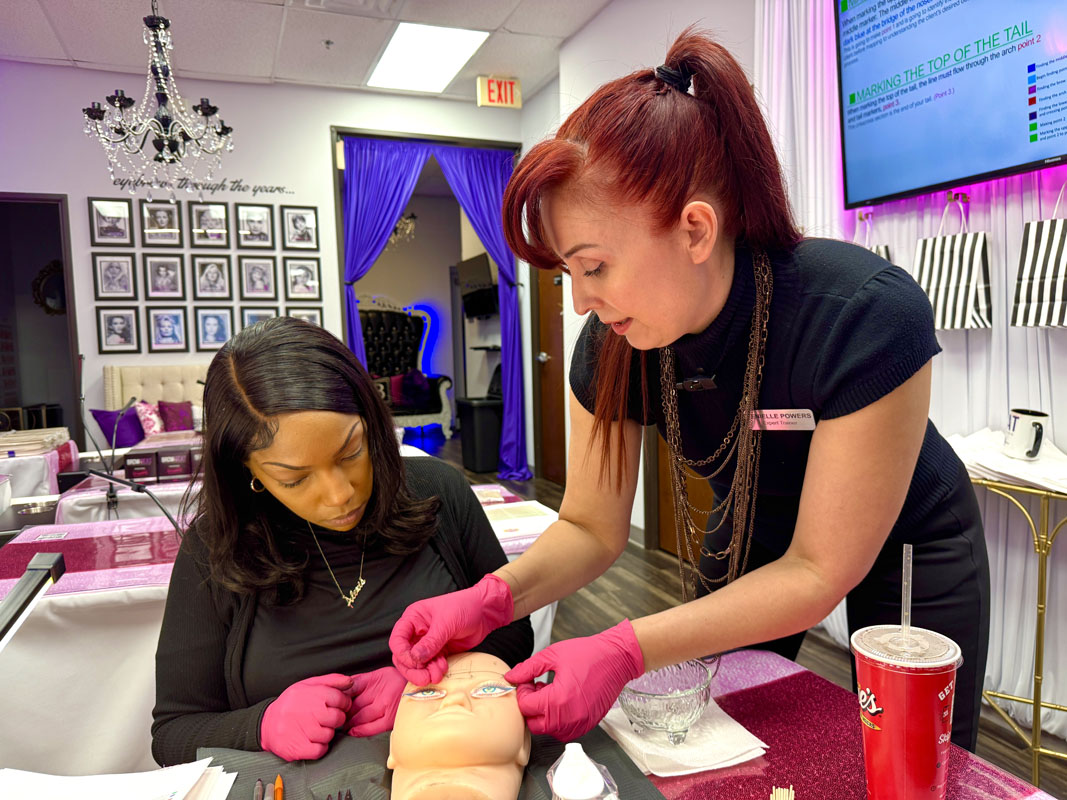 Trainer correcting student’s hand position during Texas certification Instructor helping beginner with mapping in class