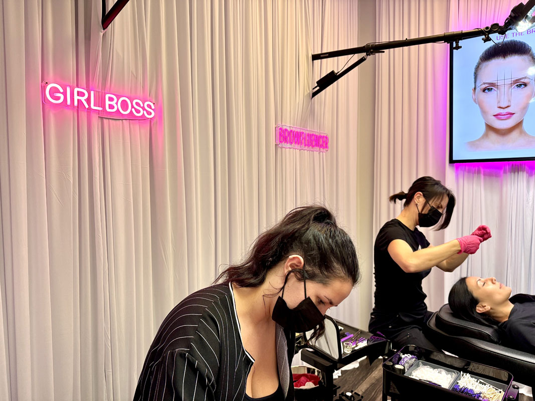 Students practicing partner brow mapping Dallas training