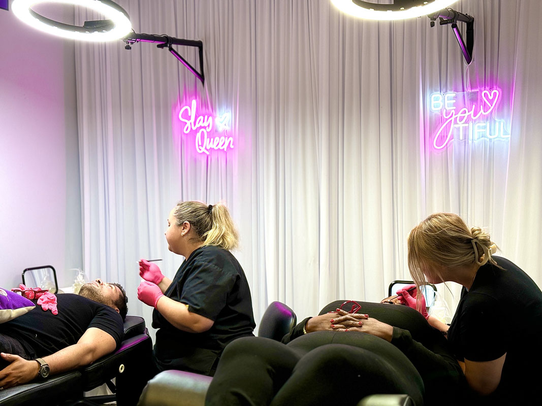 Student practicing brow mapping with string on partner in 3-in-1 course Partner exercise using mapping string to mark brow start, arch, and tail